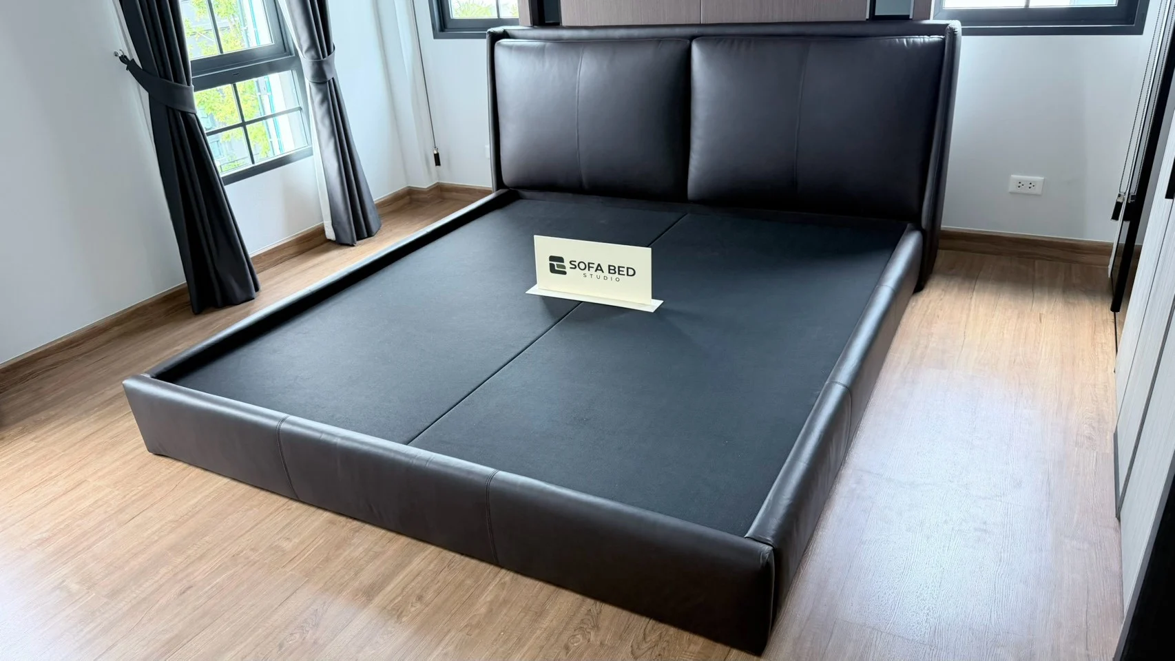 Dark tall-headboard bed with a matching base beside a window · Sofa Bed Studio · LB-024