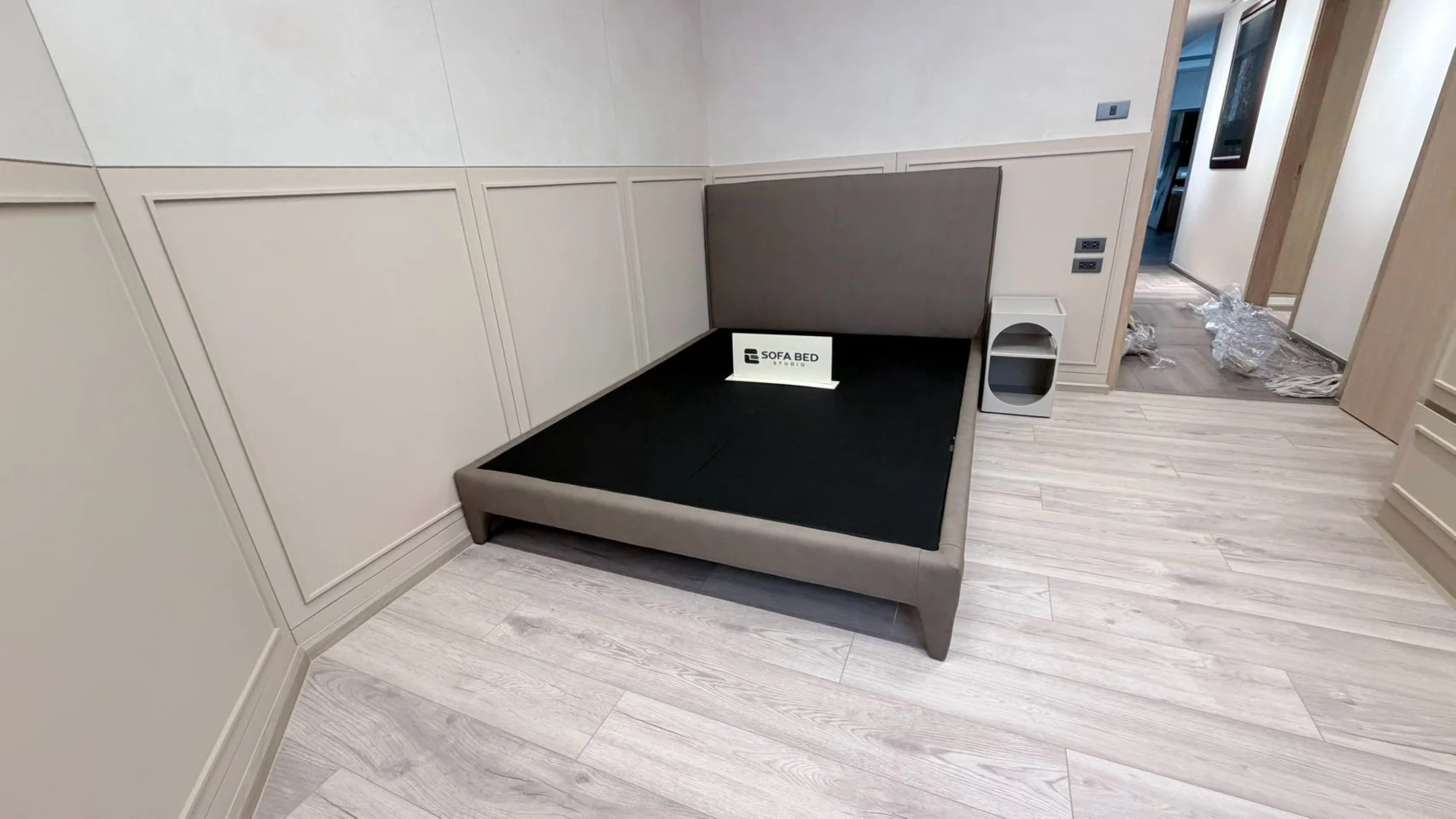 Dark grey tall-headboard bed against a light wall · Sofa Bed Studio · LB-025